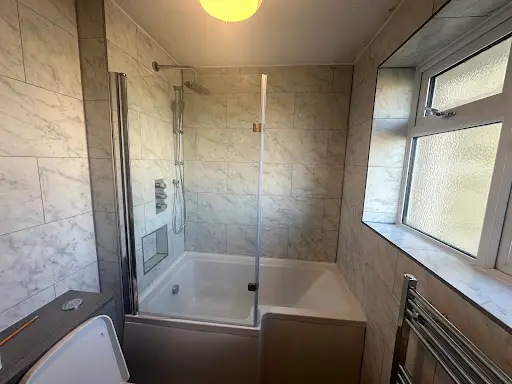 Bathroom refit with P-shaped shower bath and glass screen